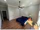 Bright bedroom with hardwood floors, ceiling fan, and ensuite access at 223 E Nash St, Spring Hope, NC 27882