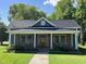 Charming single Gathering home with stone accents, inviting front porch, and well-manicured lawn at 223 E Nash St, Spring Hope, NC 27882
