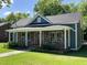 Charming home featuring a stone facade, covered porch, and well-maintained landscaping at 223 E Nash St, Spring Hope, NC 27882