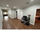 Spacious hallway with hardwood floors, white trim, recessed lighting, and doors leading to various rooms at 223 E Nash St, Spring Hope, NC 27882