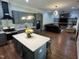 Open concept kitchen flows to living room featuring a center island with seating and modern lighting at 223 E Nash St, Spring Hope, NC 27882