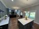 Open concept kitchen flows to living room featuring a center island with seating and modern lighting at 223 E Nash St, Spring Hope, NC 27882