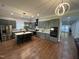 Modern kitchen with gray cabinets, stainless steel appliances, island with seating, and beautiful hardwood floors at 223 E Nash St, Spring Hope, NC 27882