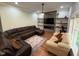 Cozy living room with stone fireplace, shelving, large sectional sofa, and natural light at 223 E Nash St, Spring Hope, NC 27882
