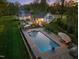 Expansive backyard with a large swimming pool, outdoor kitchen, and patio area, perfect for entertaining at 2259 Helena Moriah Rd, Timberlake, NC 27583