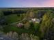 Stunning aerial view of a home with a pool surrounded by lush greenery and trees at 2259 Helena Moriah Rd, Timberlake, NC 27583