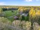 Wide aerial shot showcasing a house with a big yard and a surrounding forest at 2259 Helena Moriah Rd, Timberlake, NC 27583