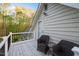 Balcony with wicker furniture and a view of the trees at 2259 Helena Moriah Rd, Timberlake, NC 27583