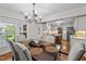 Elegant dining area with a chandelier and views into the kitchen at 2259 Helena Moriah Rd, Timberlake, NC 27583