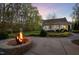 Backyard fire pit with stone surround and a cozy seating area near a well-manicured yard at 2259 Helena Moriah Rd, Timberlake, NC 27583