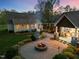 Outdoor fire pit with seating area, perfect for entertaining, and a path to a covered patio at 2259 Helena Moriah Rd, Timberlake, NC 27583