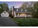 Charming home features a welcoming front porch, manicured lawn, and mature trees at twilight at 2259 Helena Moriah Rd, Timberlake, NC 27583