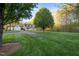 Charming house with a manicured lawn, mature trees, and a long driveway leading to a garage at 2259 Helena Moriah Rd, Timberlake, NC 27583