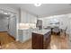 Open kitchen with island, granite countertops and hardwood floors, and dining room beyond at 2259 Helena Moriah Rd, Timberlake, NC 27583