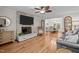 Inviting living room with a stone fireplace, hardwood floors, and open access to the dining area at 2259 Helena Moriah Rd, Timberlake, NC 27583