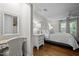 Well-lit main bedroom with desk, hardwood floors, and ensuite bathroom access at 2259 Helena Moriah Rd, Timberlake, NC 27583