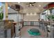 Well-equipped outdoor kitchen featuring grill, sink, bar seating, and ample counter space at 2259 Helena Moriah Rd, Timberlake, NC 27583