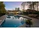 Outdoor in-ground pool with lounge seating, perfect for evening relaxation under the stars at 2259 Helena Moriah Rd, Timberlake, NC 27583