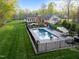 Aerial view of a backyard oasis featuring a fenced pool, lounge chairs, and lush landscaping at 2259 Helena Moriah Rd, Timberlake, NC 27583
