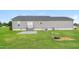 Home exterior showcasing a well-maintained lawn and a patio area perfect for outdoor living at 24 Cider Ct, Benson, NC 27504
