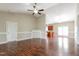 Open-concept living room with beautiful hardwood floors and a decorative fireplace flowing into the kitchen at 24 Cider Ct, Benson, NC 27504