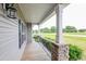 Inviting covered front porch featuring sturdy stone pillars, a wooden deck, and great neighborhood views at 24 Cider Ct, Benson, NC 27504