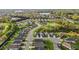 An aerial view captures a serene neighborhood featuring winding roads, lush greenery, and tranquil ponds at 252 Tyree Trl, Burlington, NC 27215