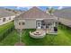 Aerial view of a backyard with a fire pit, patio, and screened-in porch at 252 Tyree Trl, Burlington, NC 27215