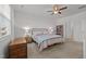 Comfortable bedroom with a cozy bed, ceiling fan, and natural light at 252 Tyree Trl, Burlington, NC 27215