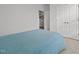 Bright bedroom featuring a blue quilted bedspread and white doors at 252 Tyree Trl, Burlington, NC 27215