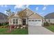 Charming single-Gathering home features a well-manicured lawn, two car garage and beautiful landscaping at 252 Tyree Trl, Burlington, NC 27215