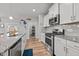 Bright kitchen showcasing granite countertops, stainless steel appliances, and open shelving at 252 Tyree Trl, Burlington, NC 27215