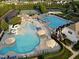 Aerial view of a community pool area featuring multiple pools, a slide, and a tennis court at 252 Tyree Trl, Burlington, NC 27215