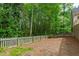 A fenced backyard with mature trees provides privacy and a natural setting at 2720 Townedge Ct, Raleigh, NC 27612