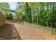 Backyard features a wooden fence and mature trees providing privacy and shade at 2720 Townedge Ct, Raleigh, NC 27612