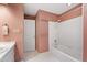 Bathroom with floral wallpaper, white trim, and a combined shower and tub at 2720 Townedge Ct, Raleigh, NC 27612