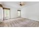 Spacious bedroom with carpet, two windows and a ceiling fan at 2720 Townedge Ct, Raleigh, NC 27612