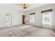 Bedroom with neutral carpet, two windows, and ceiling fan at 2720 Townedge Ct, Raleigh, NC 27612
