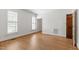 Bright bedroom featuring wood floors, white walls, and shuttered windows at 2720 Townedge Ct, Raleigh, NC 27612