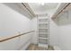 Walk-in closet with built-in shelving and wooden rails for ample storage space at 2720 Townedge Ct, Raleigh, NC 27612