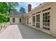 Wide deck with multiple doors leading inside and a gray floor at 2720 Townedge Ct, Raleigh, NC 27612