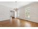 Bright dining room with hardwood floors, wainscoting, and a chandelier at 2720 Townedge Ct, Raleigh, NC 27612