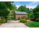 Brick home with lush green landscaping and a circular driveway at 2720 Townedge Ct, Raleigh, NC 27612
