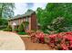 Brick house with a circular driveway and blooming flower beds at 2720 Townedge Ct, Raleigh, NC 27612