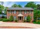 Charming brick two-story home with green shutters and manicured landscaping at 2720 Townedge Ct, Raleigh, NC 27612