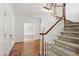 Bright foyer with hardwood floors, staircase, and views into adjacent rooms at 2720 Townedge Ct, Raleigh, NC 27612