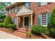 A welcoming brick front entrance with a dark green door and manicured landscaping at 2720 Townedge Ct, Raleigh, NC 27612