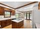 Spacious kitchen featuring wood cabinets, center island with marble counters, and stainless appliances at 2720 Townedge Ct, Raleigh, NC 27612
