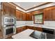 Bright kitchen features custom wood cabinets, marble counters, stainless appliances and hardwood flooring at 2720 Townedge Ct, Raleigh, NC 27612
