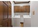 Laundry room with washer, dryer and wooden cabinets at 2720 Townedge Ct, Raleigh, NC 27612
